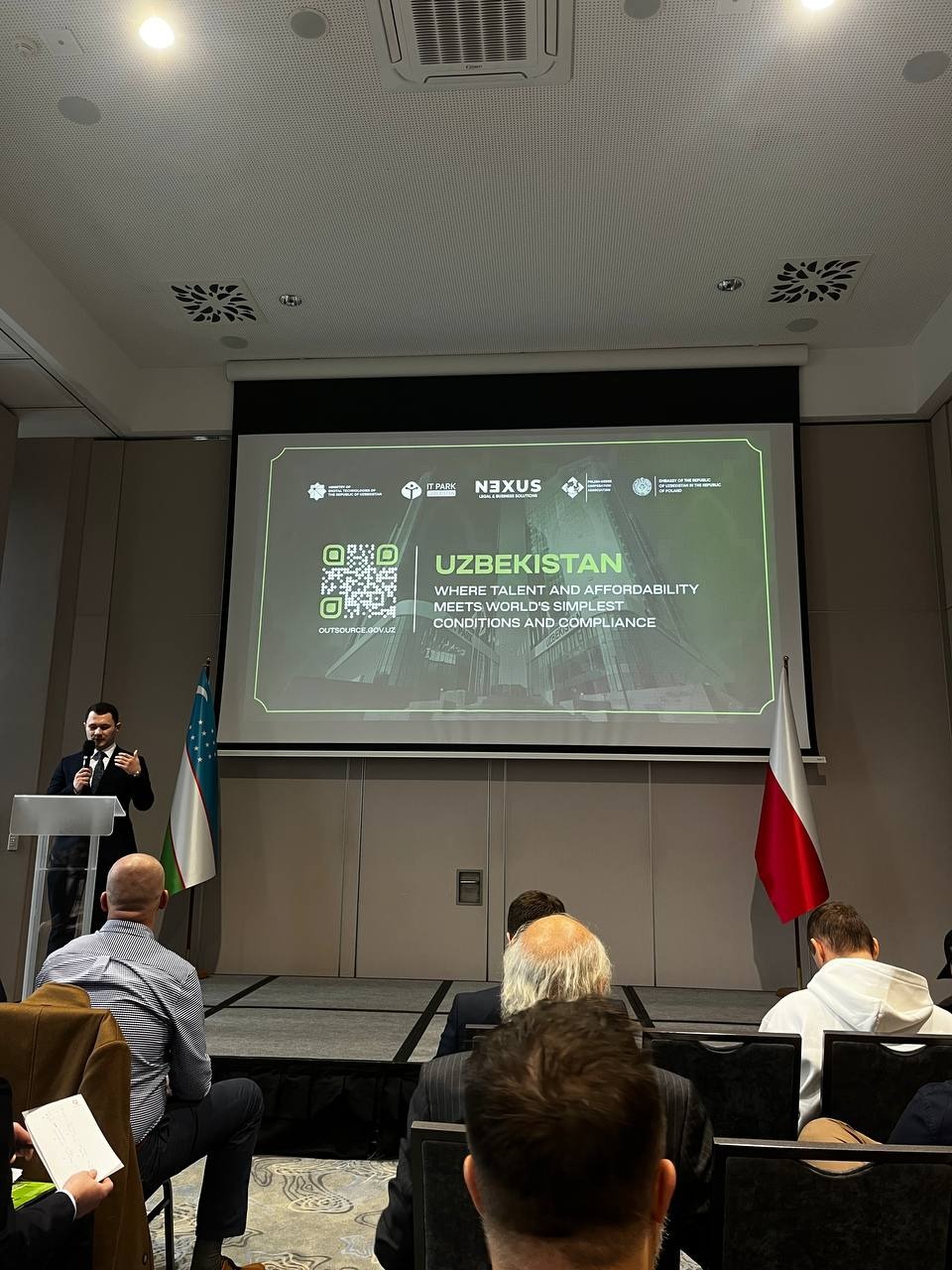 Representatives of IT Park Uzbekistan speaking at Uzbekistan Outsourcing Conference in Poland, viewed from the audience